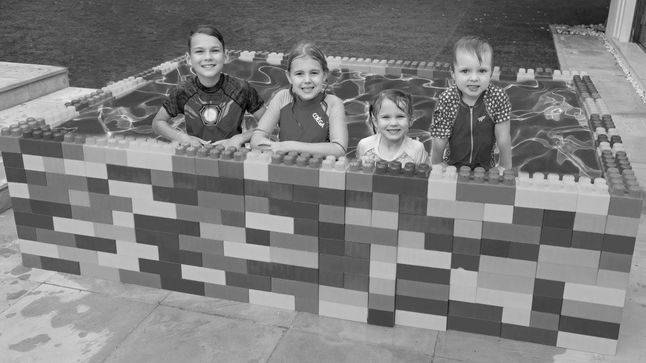 Five Children  Swim in the Children Pool and Performs with Fun Water Toys